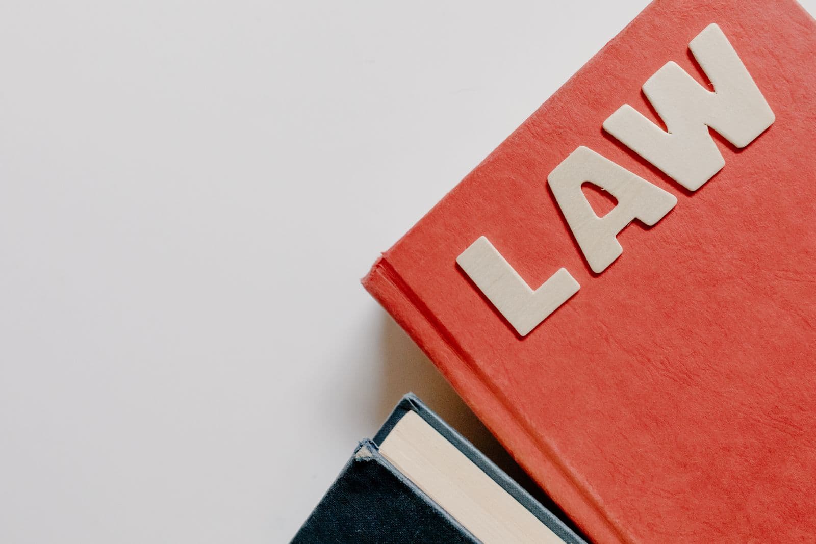 A stack of books with a law title on the top cover
