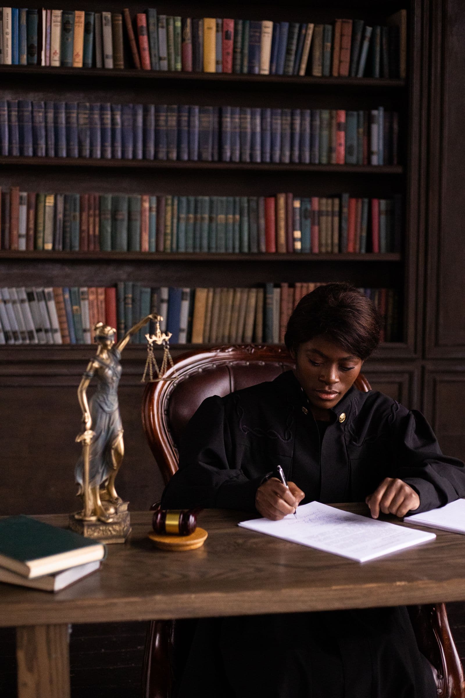 A lawyer seated at a table working through paperwork
