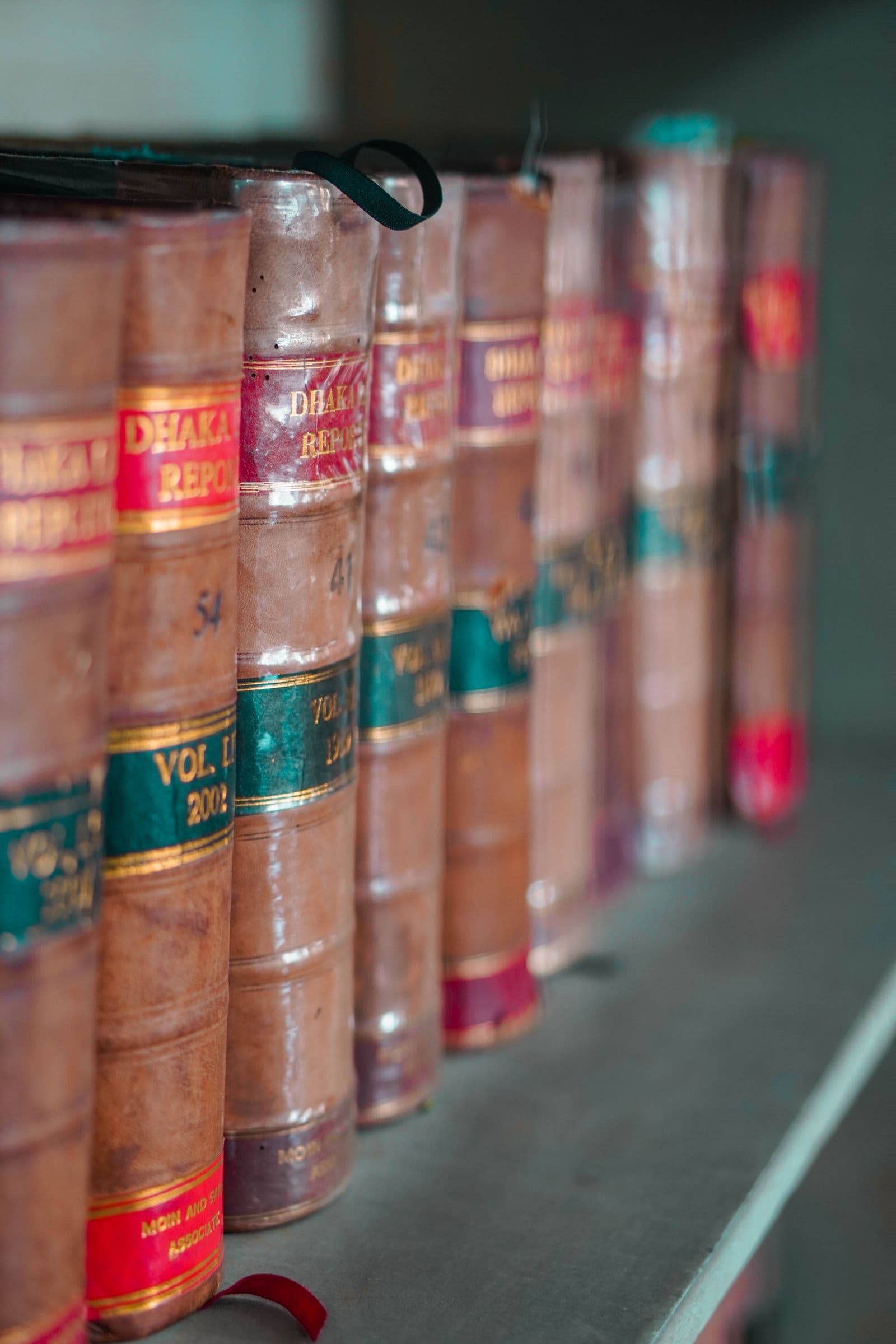 Books piled along a shelf