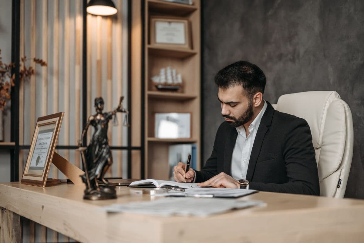 A lawyer making notes in a notebook