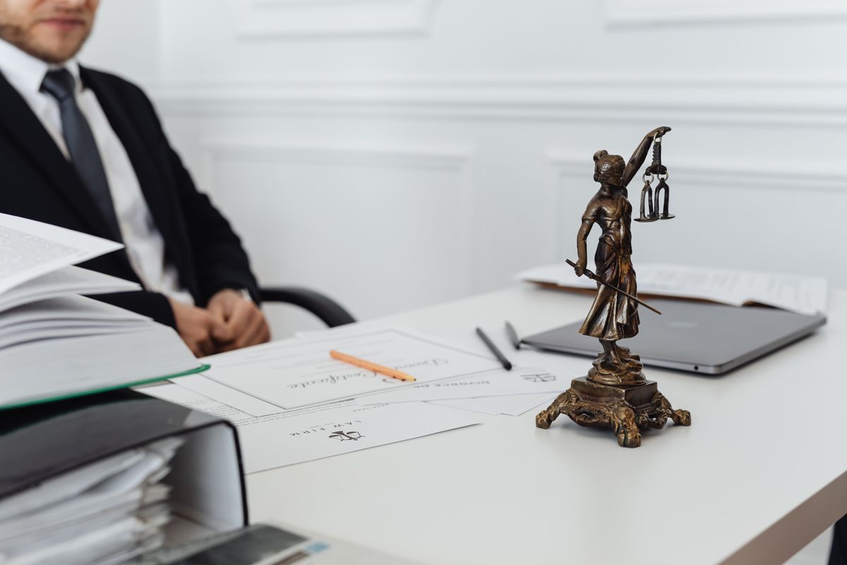 A lawyer seated behind a desk in an office