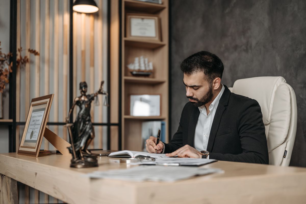 A lawyer making notes in a notebook